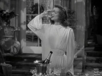 A still from the film ‘A Philidelphia Story’ of Katherine Hepburn downing a glass of champagne.