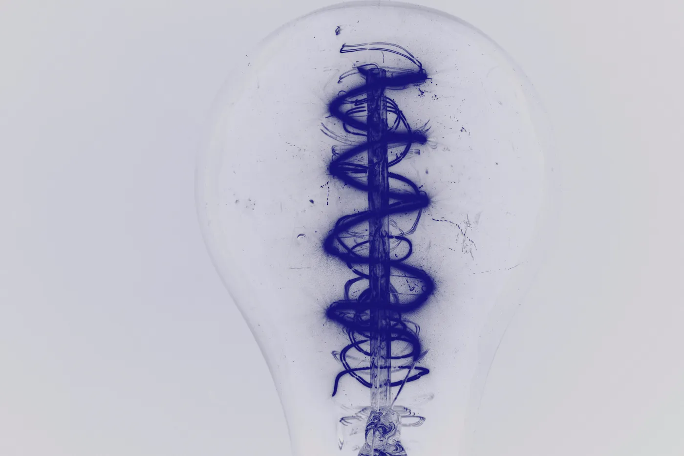 Picture of a lightbulb with a messy filament and interior, indicating the not-so-hidden messiness even good ideas can result in