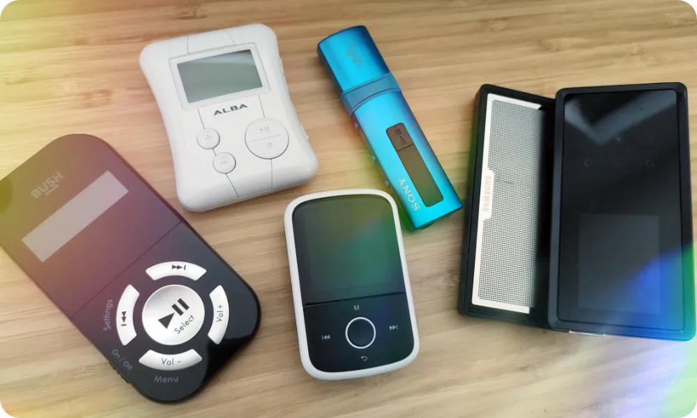 An image of five different MP3 players laying on a table